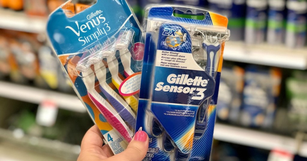 hand holding disposable razors in a store