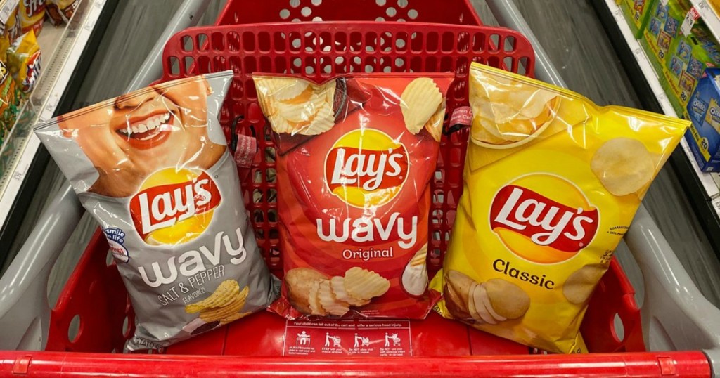 bags of potato chips in a store shopping cart