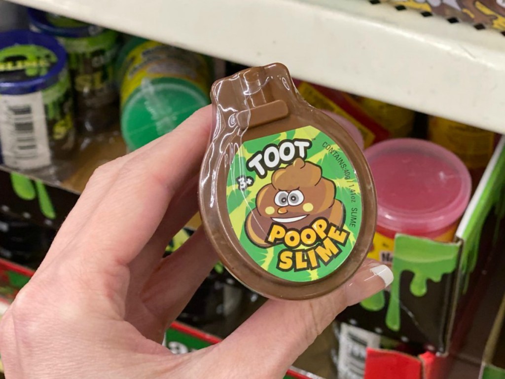 hand holding brown toy that says toot on it