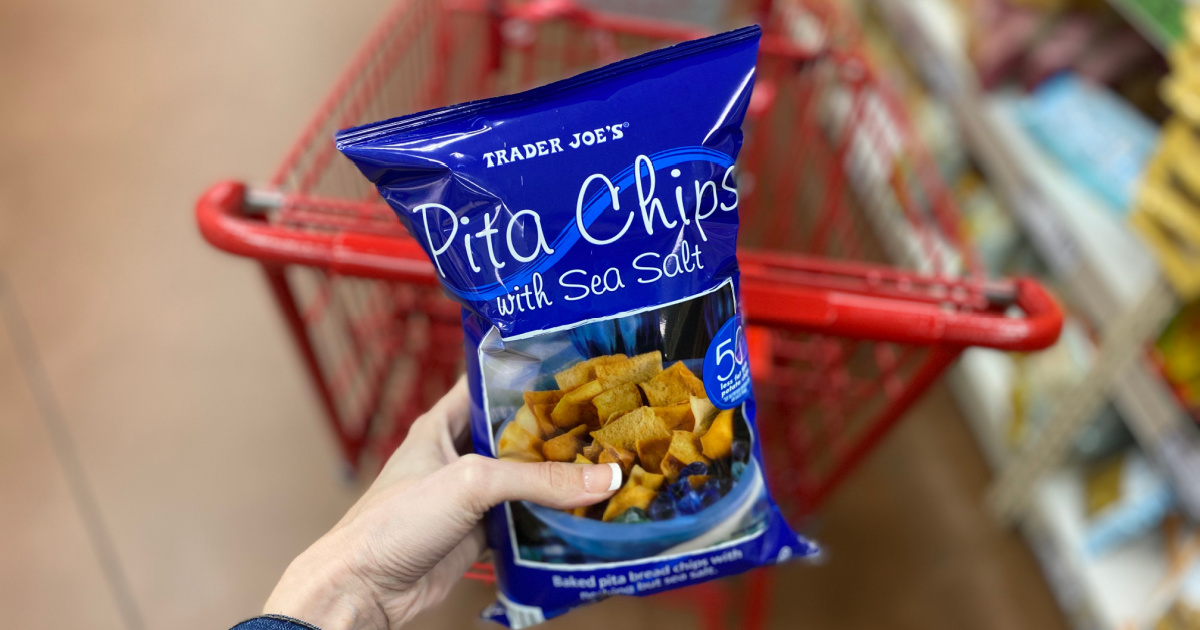 Hand holding bag of Trader Joe's store brand pita chips