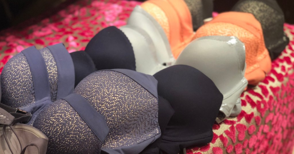 different colored bras on table with pink fur hearts