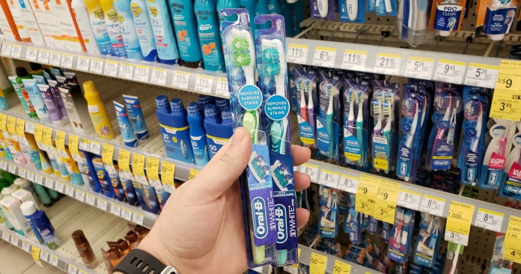 hand holding toothbrushes in a store