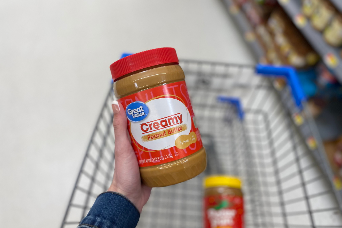 hand holding Great Value peanut butter
