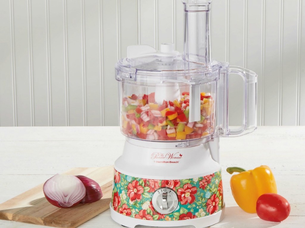 food processor on counter by onions and peppers