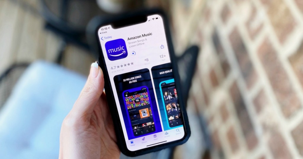 hand holding a phone showing the Amazon Music app