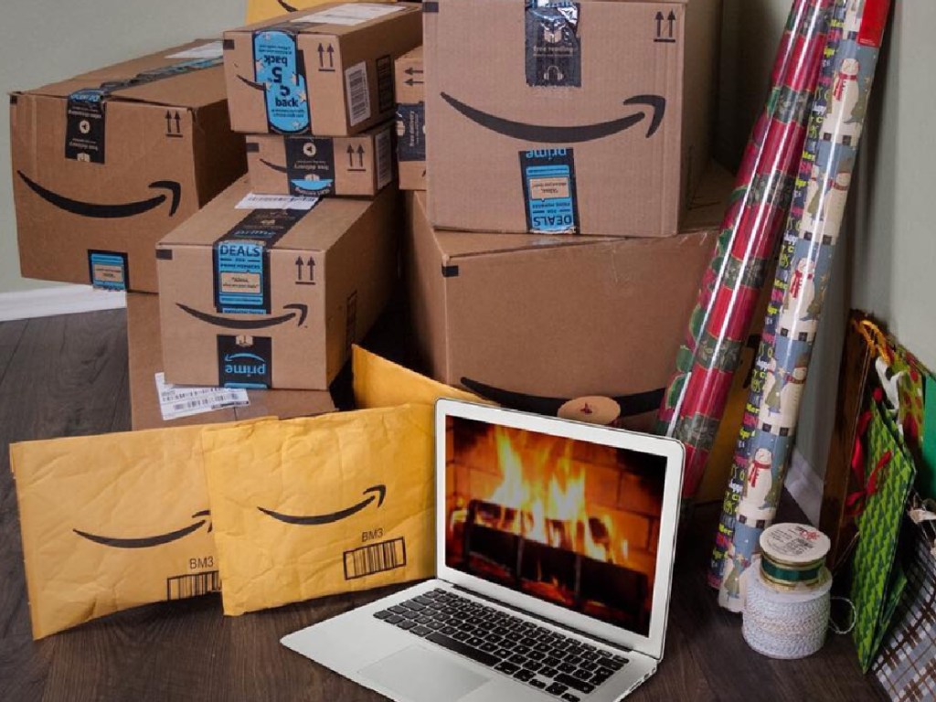 Amazon prime packages sitting next to an open laptop