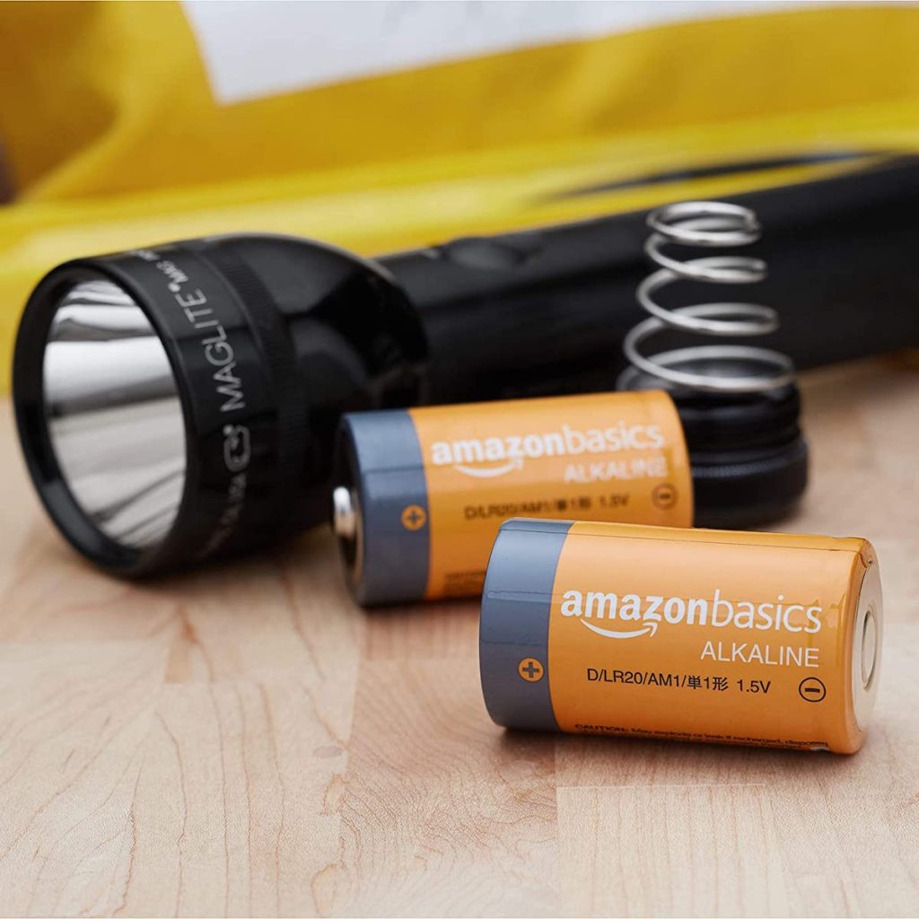 AmazonBasics D batteries next to black flashlight