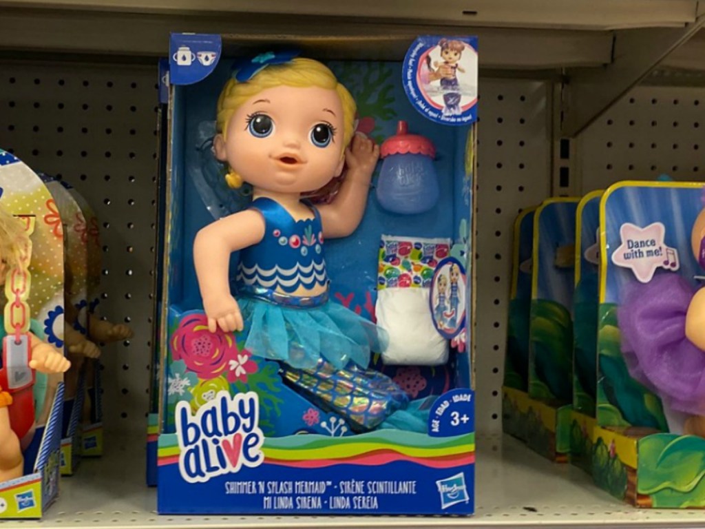 Small mermaid themed doll sitting in packing on shelf
