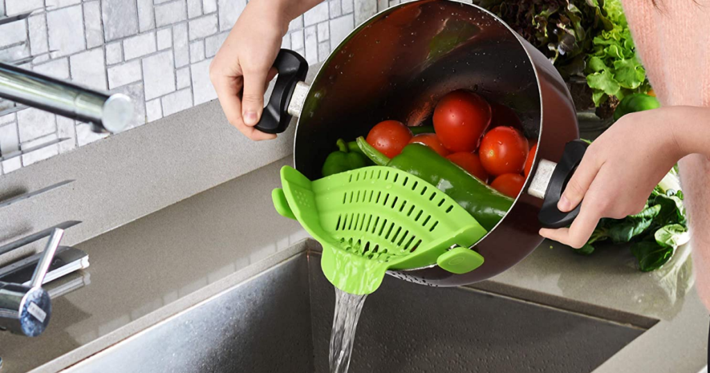 straining veggies over sink with Zulay Kitchen clip-on strainer