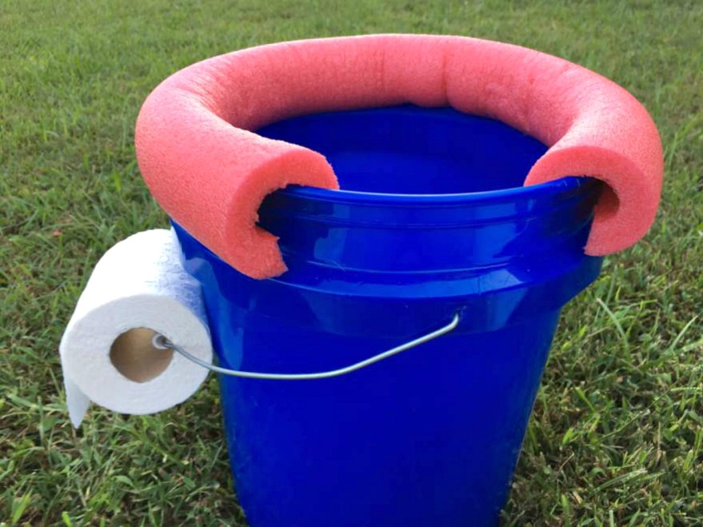 blue bucket with toilet paper camping ideas