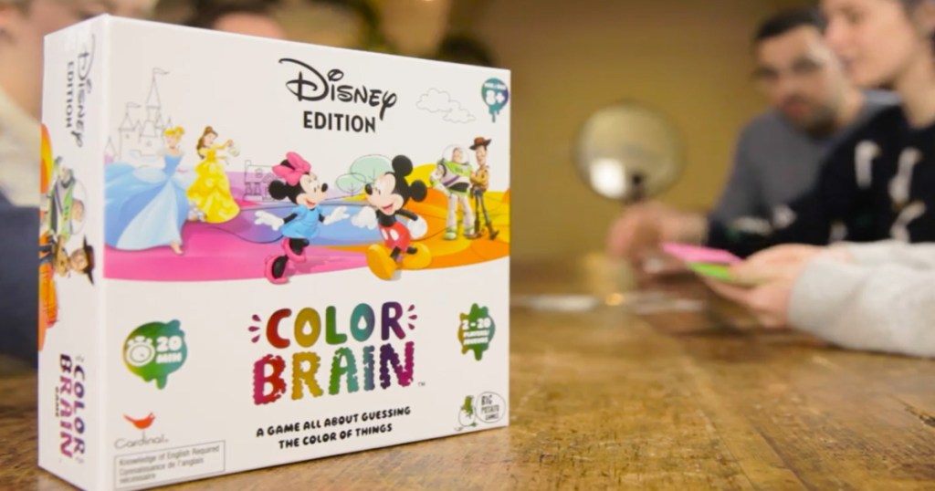 Disney Color Brain Game box on a table with kids at the table playing the game