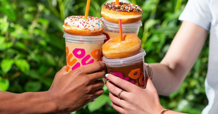 three people enjoying Dunkin donuts and coffee
