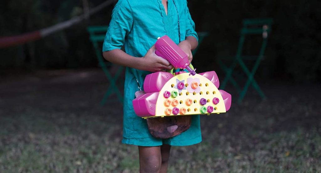 girl carrying a drill set
