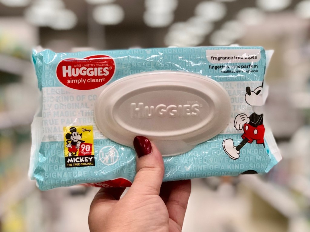 hand holding baby wipes in store aisle