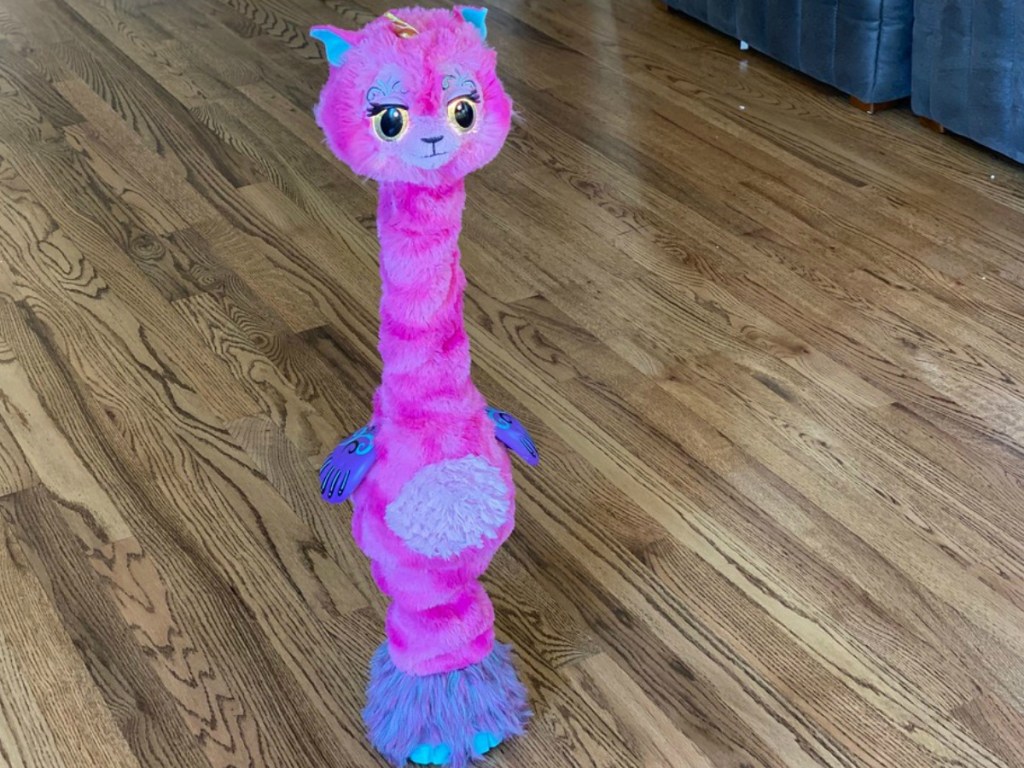 pink hatchimals llamacorn standing tall on wood floors