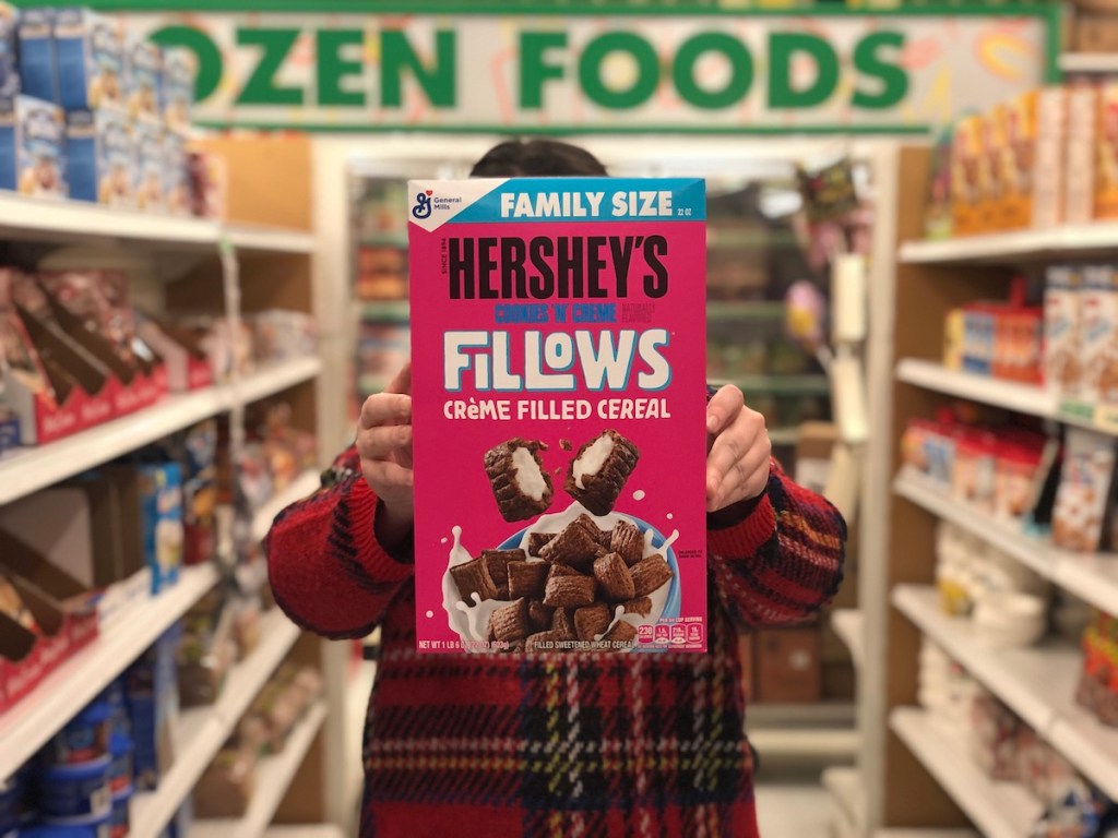 Person holding up a box of Hershey's Fillows Cereal