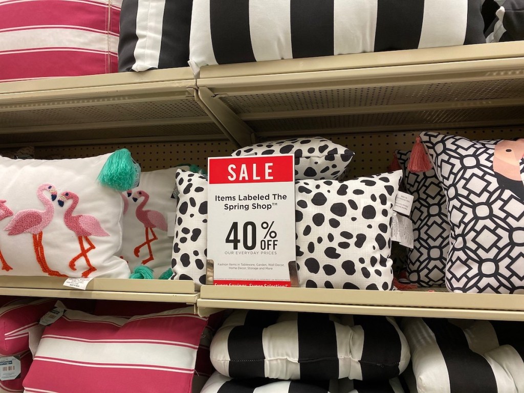 hobby lobby sale sign with flamingo pillow, black spotted pillow, and striped pillows