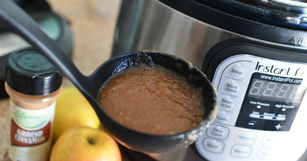 holding ladle filled with Instant Pot applesauce 
