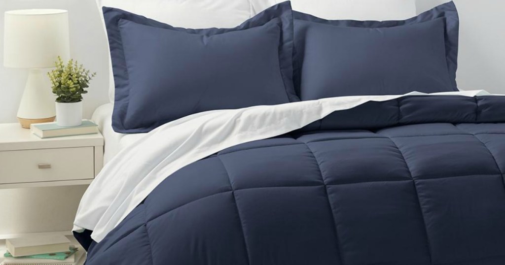 bed with navy comforter and pillows