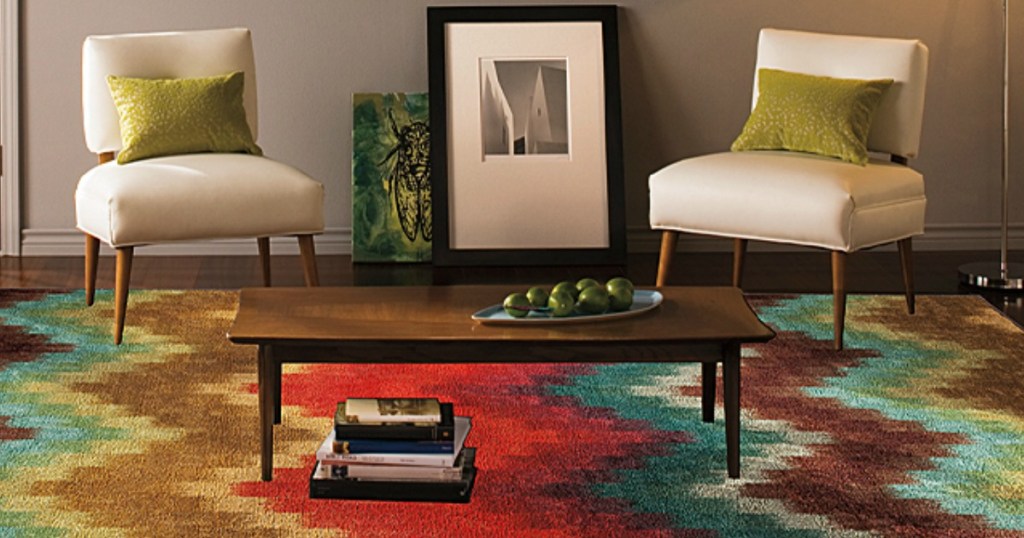 multi-color rug with a coffee table and chairs sitting on it