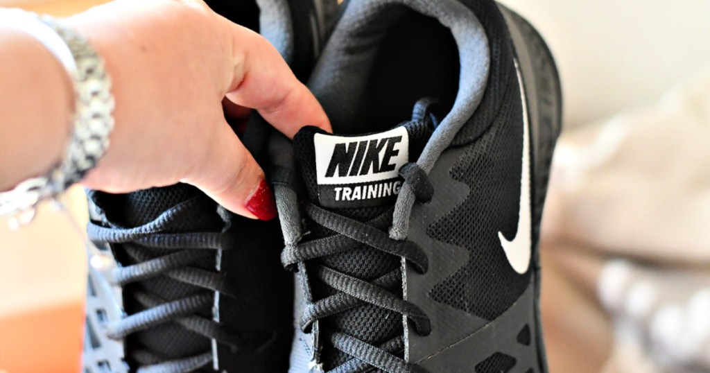 Nike Training Black sneakers in woman's hand