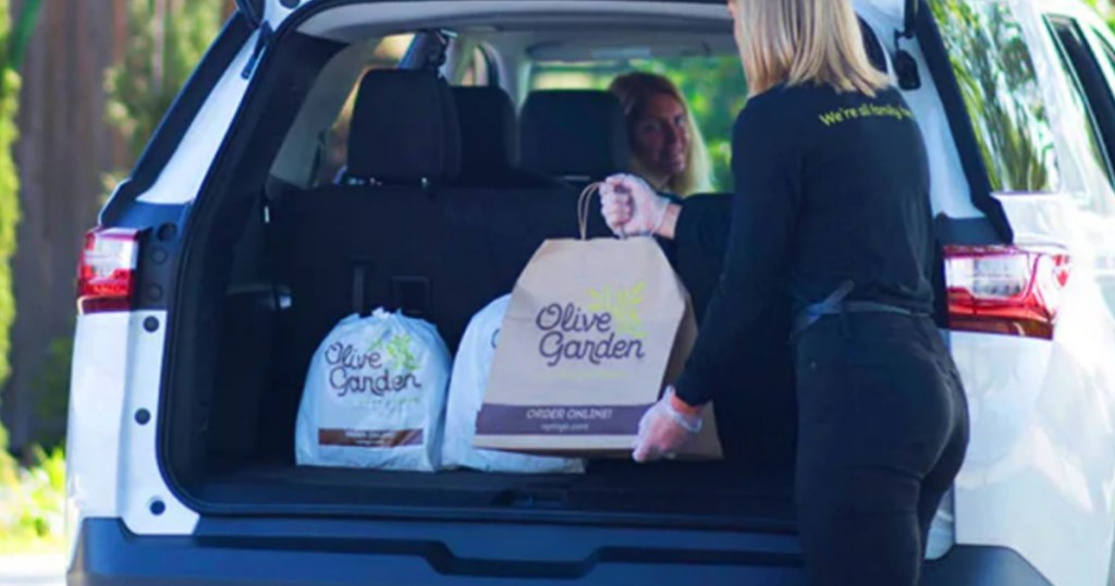 Olive Garden employee placing to-go order inside car