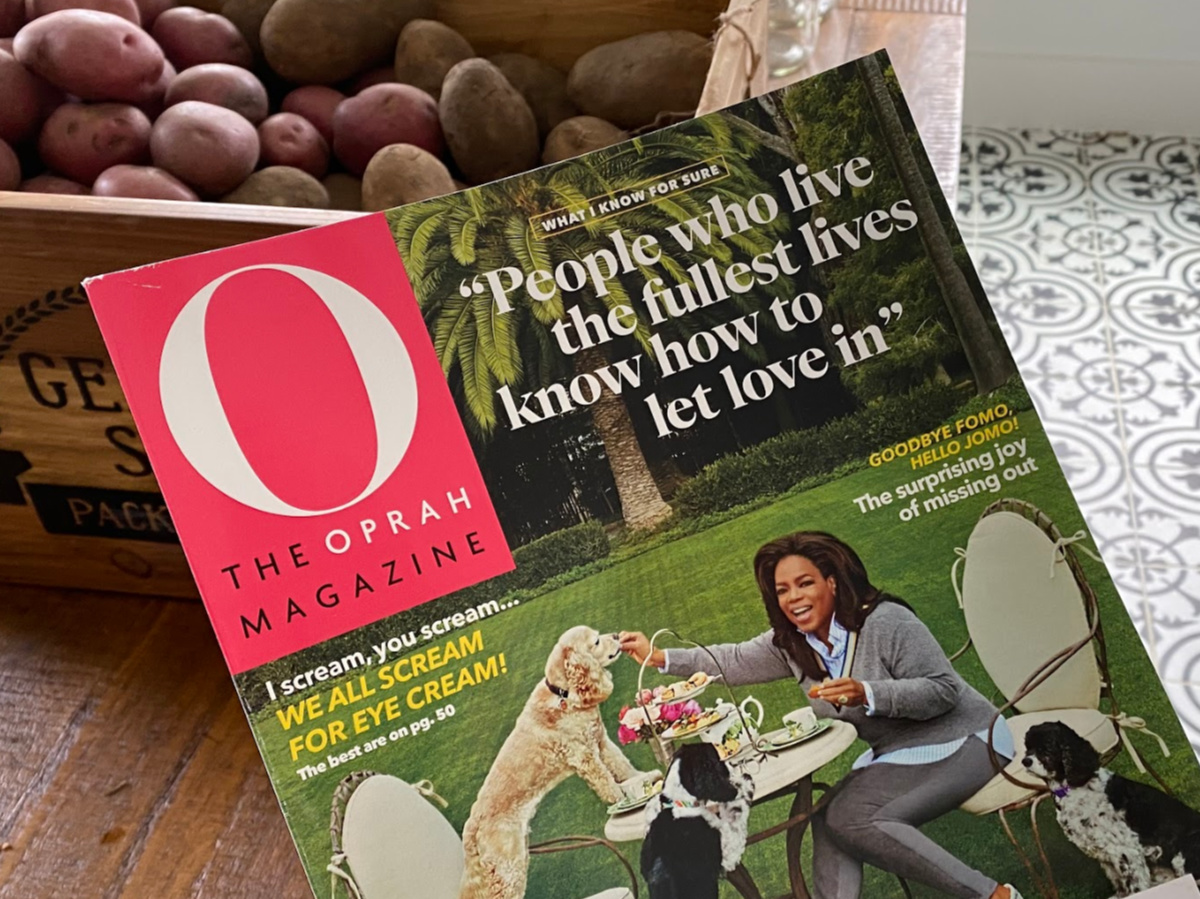 magazine in home above wood table and basket of potatoes