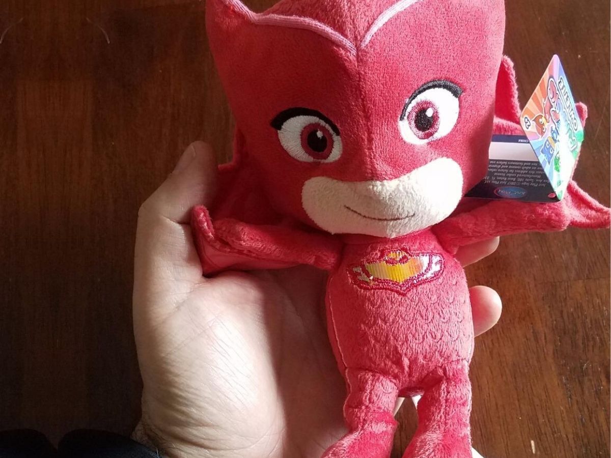 human hand holding small plush toy of Owlette from PJ Masks