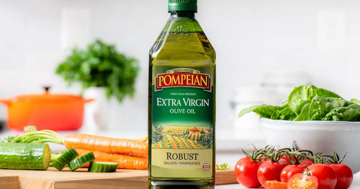 Pompeian Robust Extra Virgin Olive Oil on counter with vegetables in the background