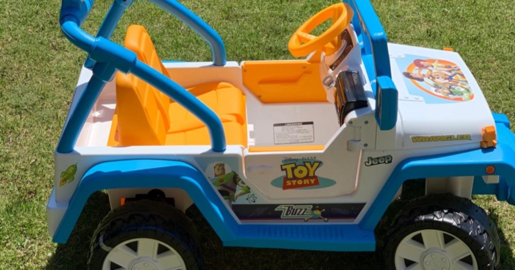 kids Toy Story ride-on jeep toy outside in grass