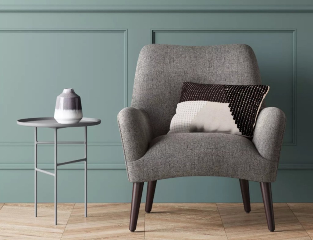 simple gray metal accent table next to a gray armchair