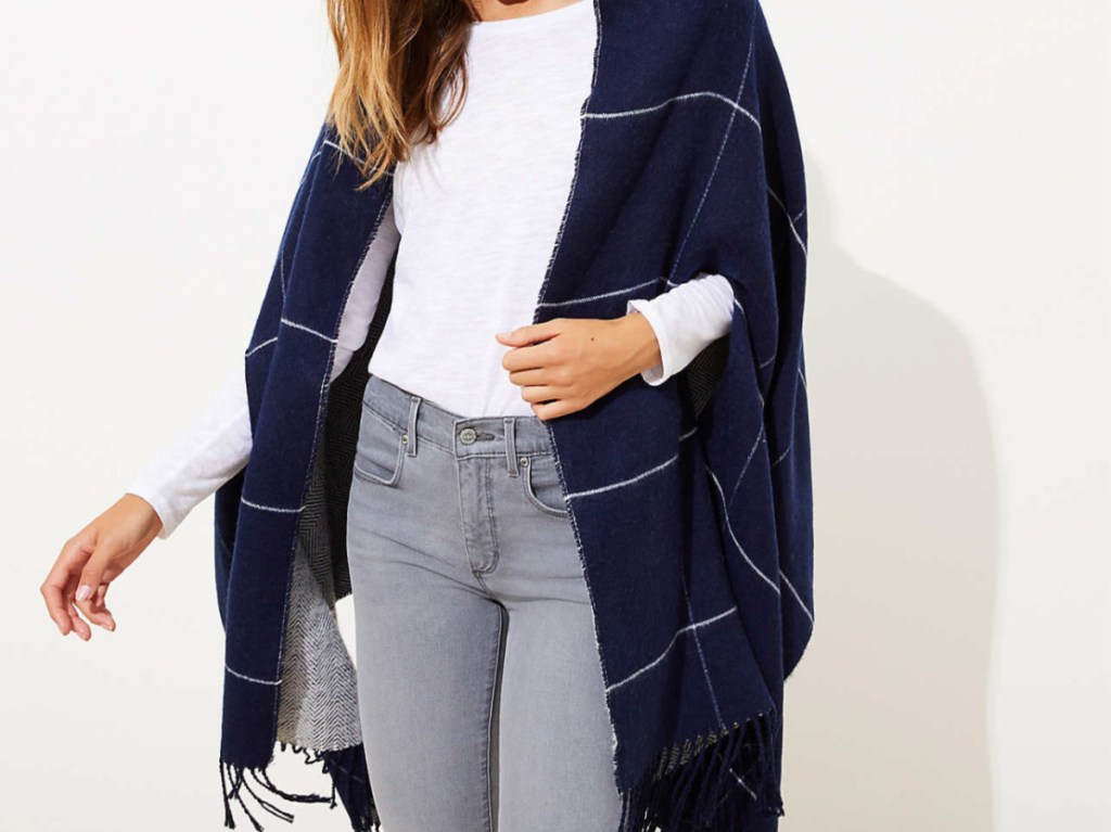 woman in dark blue fringe cape