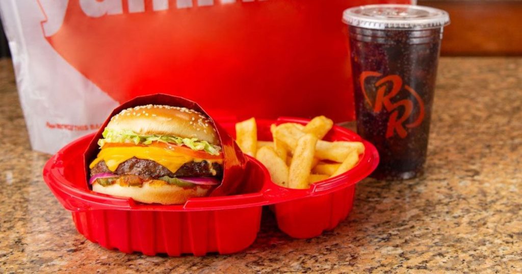 Red Robin Meal with burger, fries, and soda with to go bag in the background