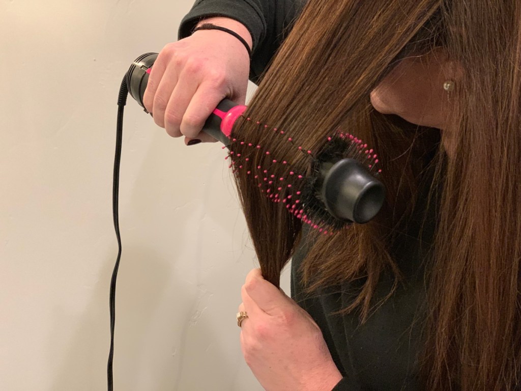 woman using Revlon drying brush on long brown hair