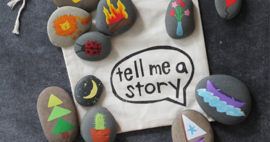 Story stones with pictures on them next to a sign reading "tell me a story"