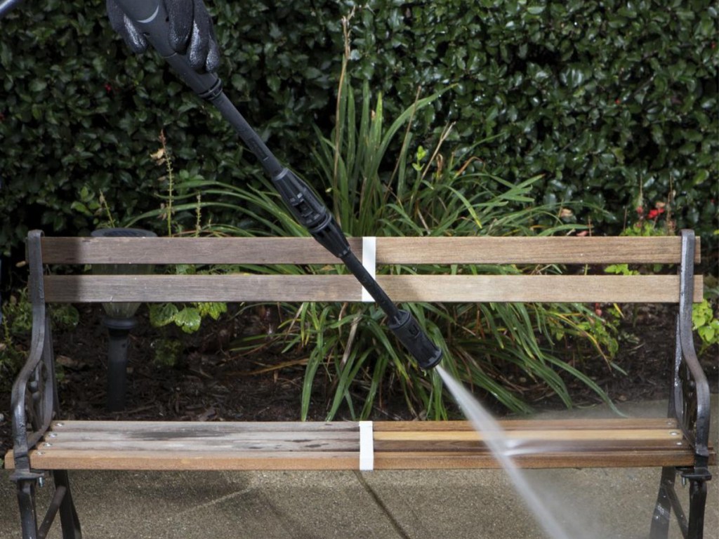 pressure washer hose being used on bench