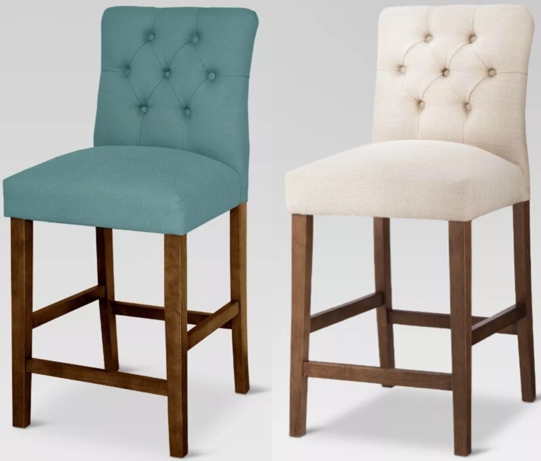 two upholstered tufted high back barstools with wooden legs