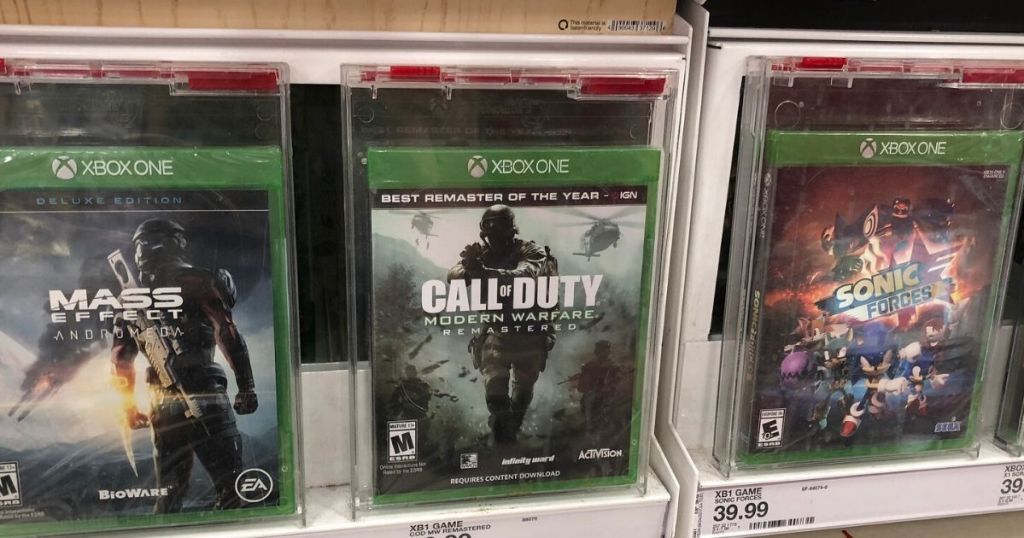 three video games on shelf at store