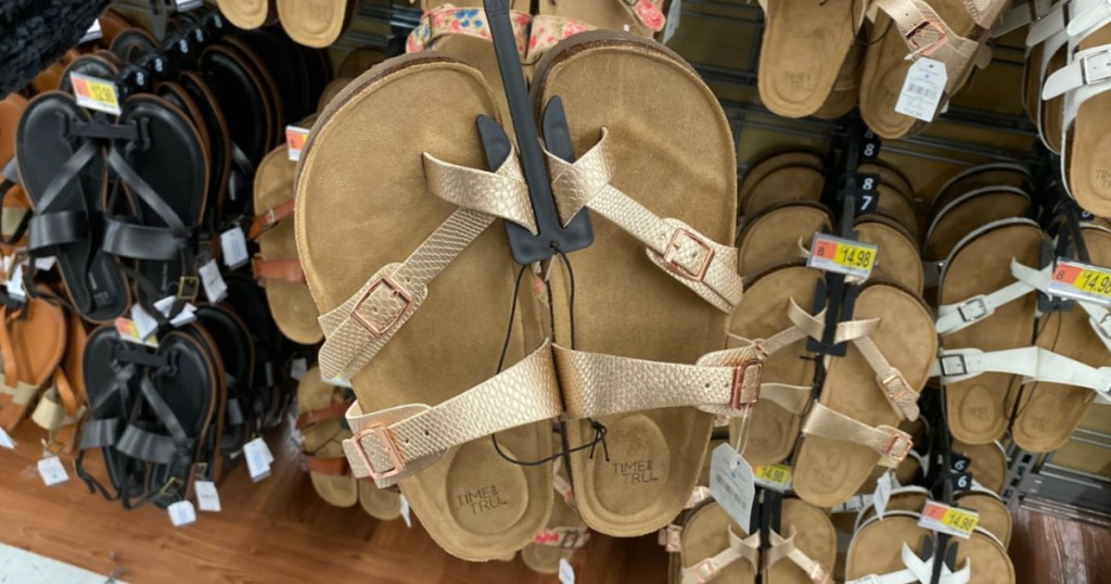 Women's gold slide sandals in store aisle