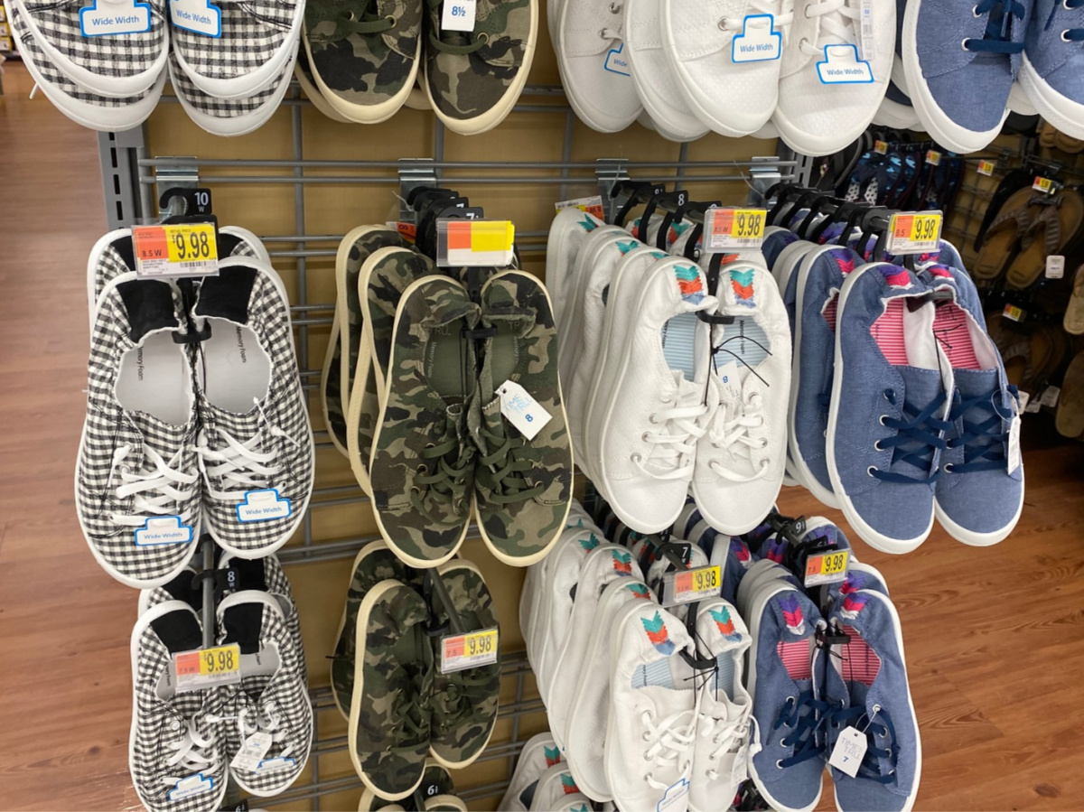 various patterned women's sneakers hanging in store aisle