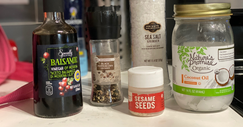 Coconut oil, balsamic vinegar, sesame seeds and salt + pepper sitting on counter