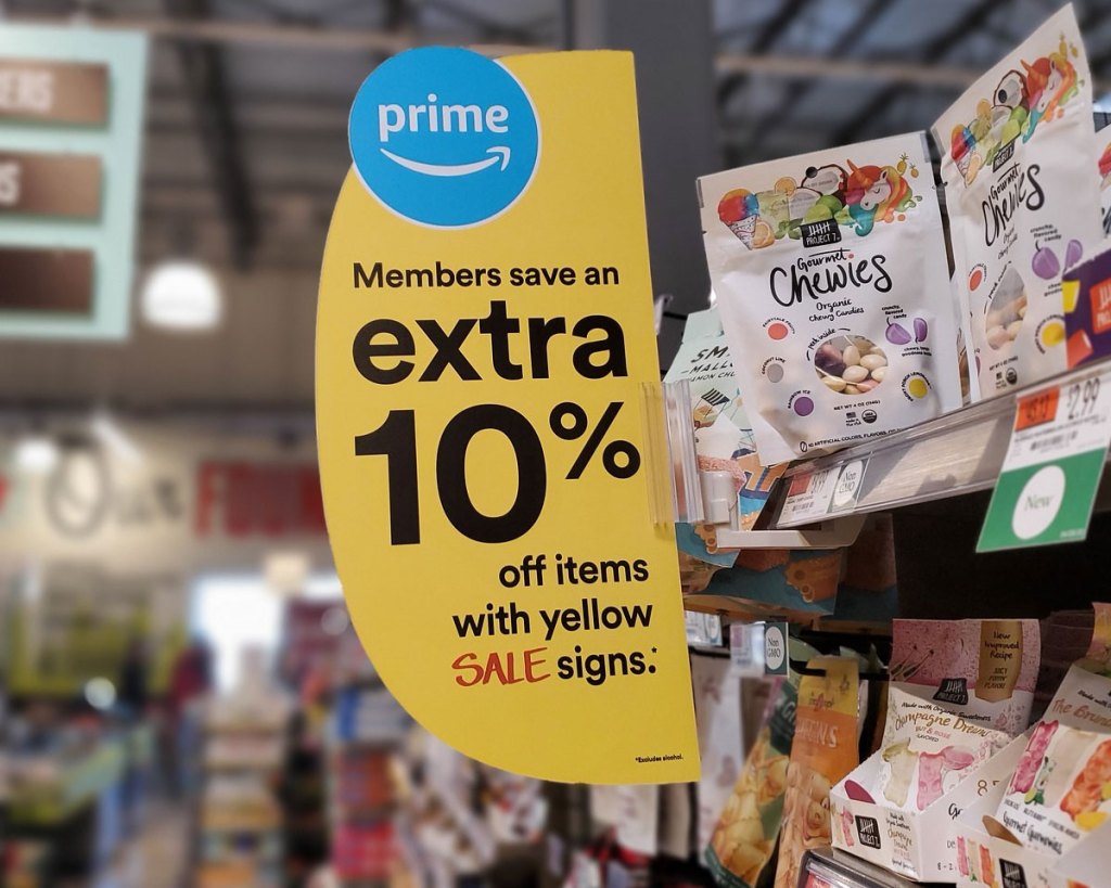 yellow sale sign on shelf at whole foods