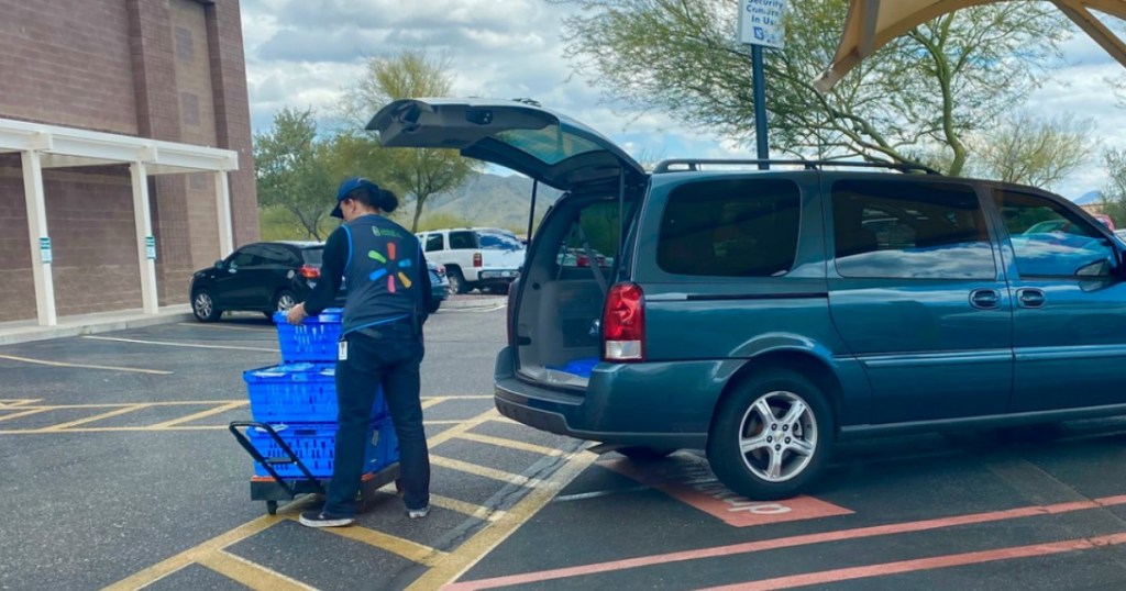Walmart Grocery Pickup cashier putting bags in van