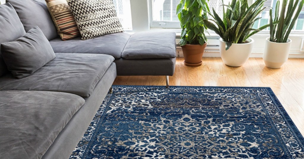 blue area rug on a wood floor with a gray couch