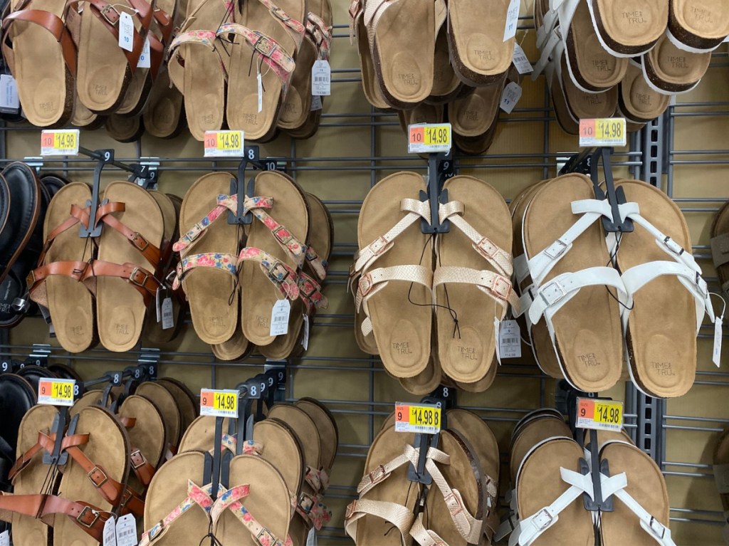 various colors of women's sandals hanging in store aisle