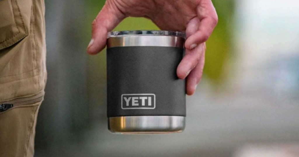 Man carrying a small YETI cup with lid