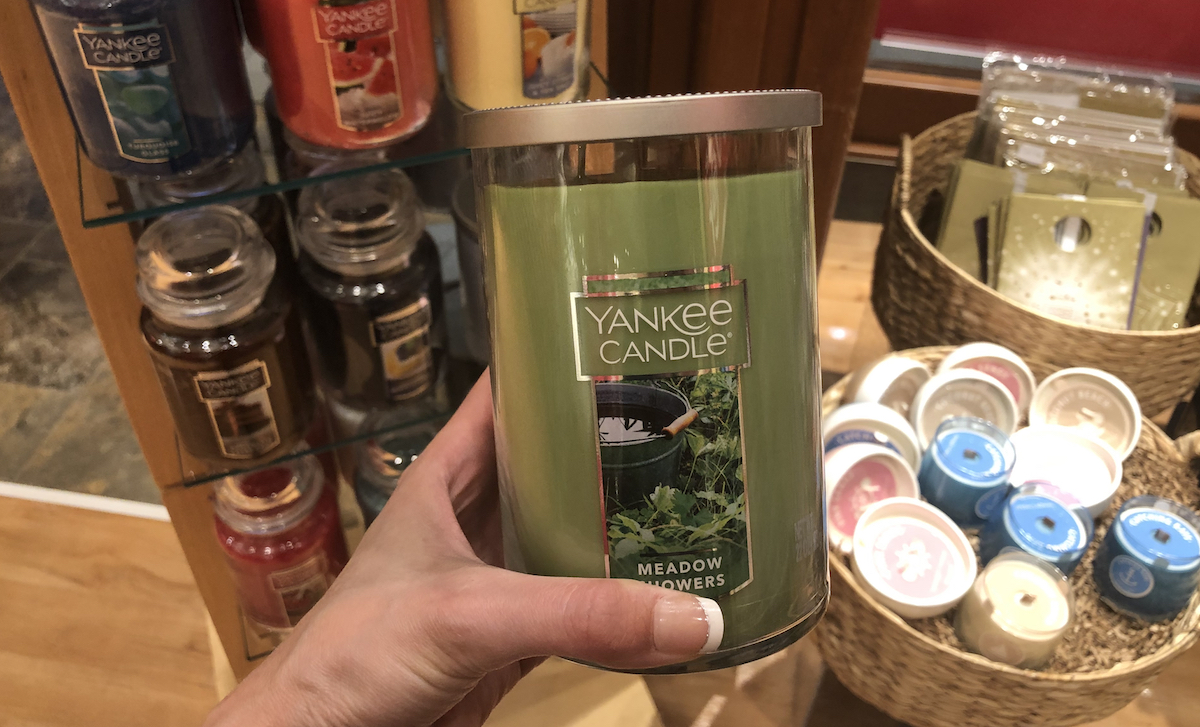 hand holding a Yankee Candle Meadow Showers