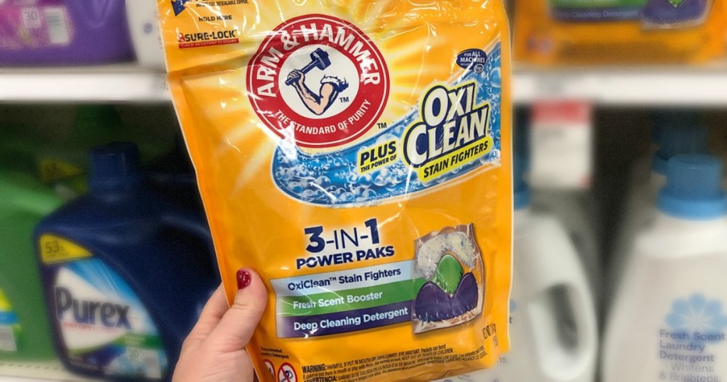 hand holding bag of laundry detergent in store