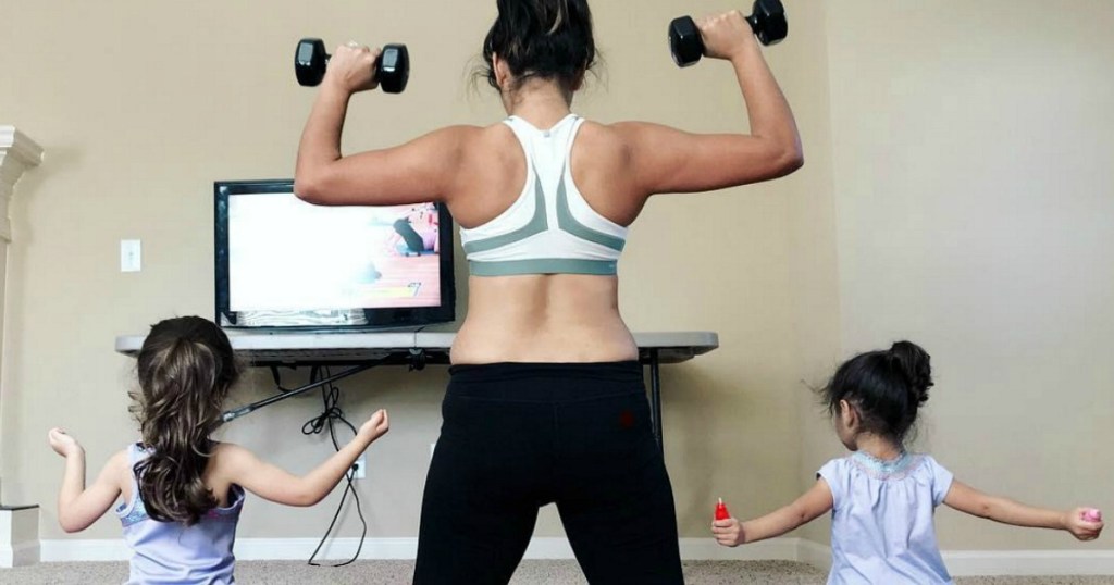 woman working out with weights and her two kids