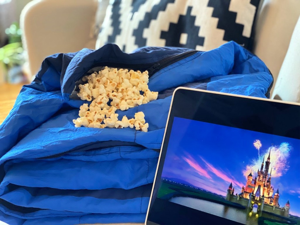 blue-blanket-filled-with-popcorn-and-computer-screen-with-disney-logo